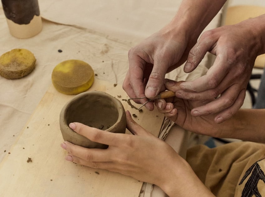 Hands working together with clay